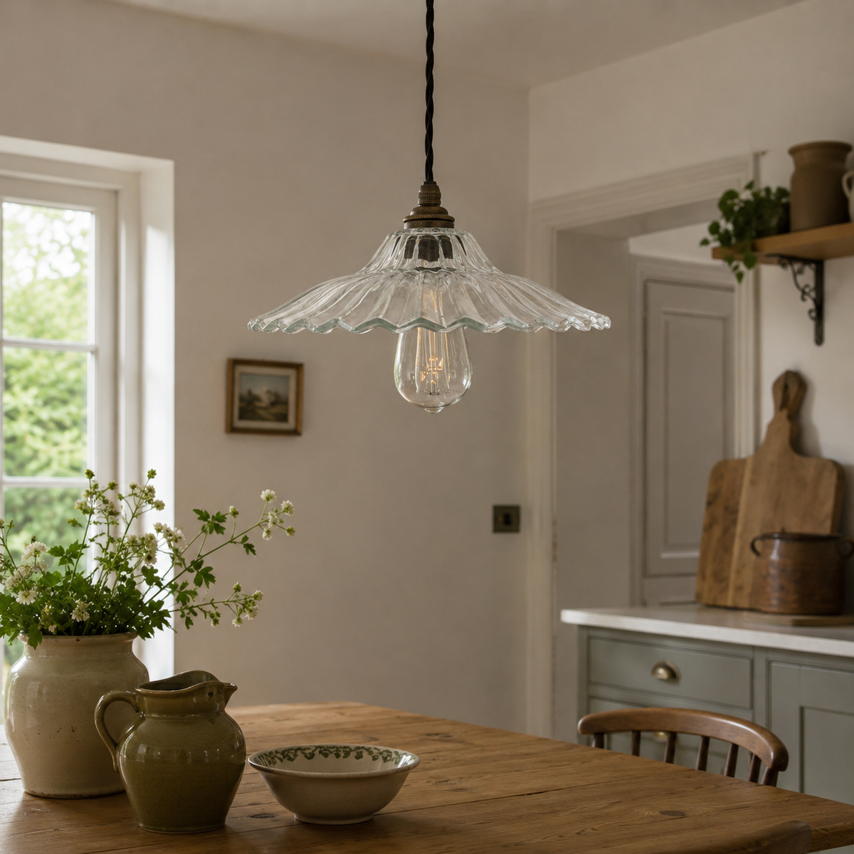 Vintage-style pendant light hanging above a wooden dining table in a cozy kitchen.