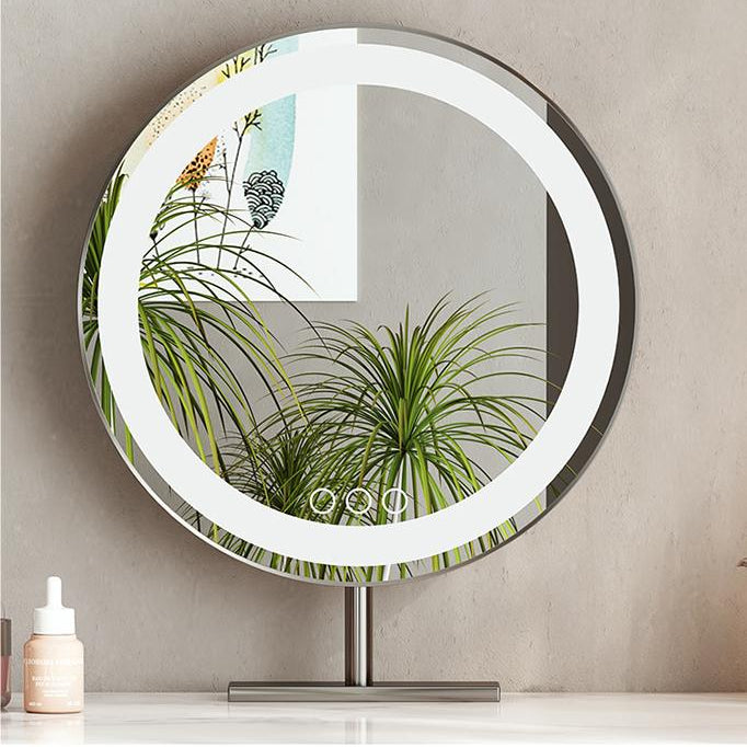 Round makeup mirror with LED lighting on a stand against a neutral wall.