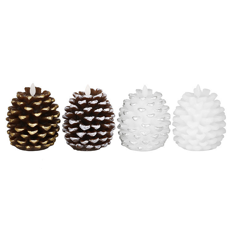 Set of four pine cone-shaped candles in gold, bronze, and white on a white background