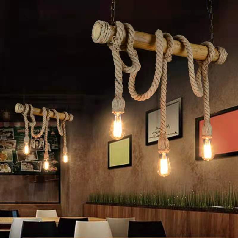 Rustic pendant lights with rope and wooden accents in a restaurant setting.
