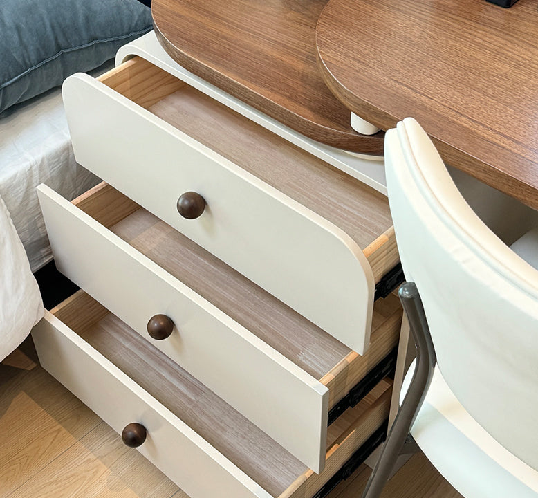 Wooden furniture with open drawers and a chair in a room setting