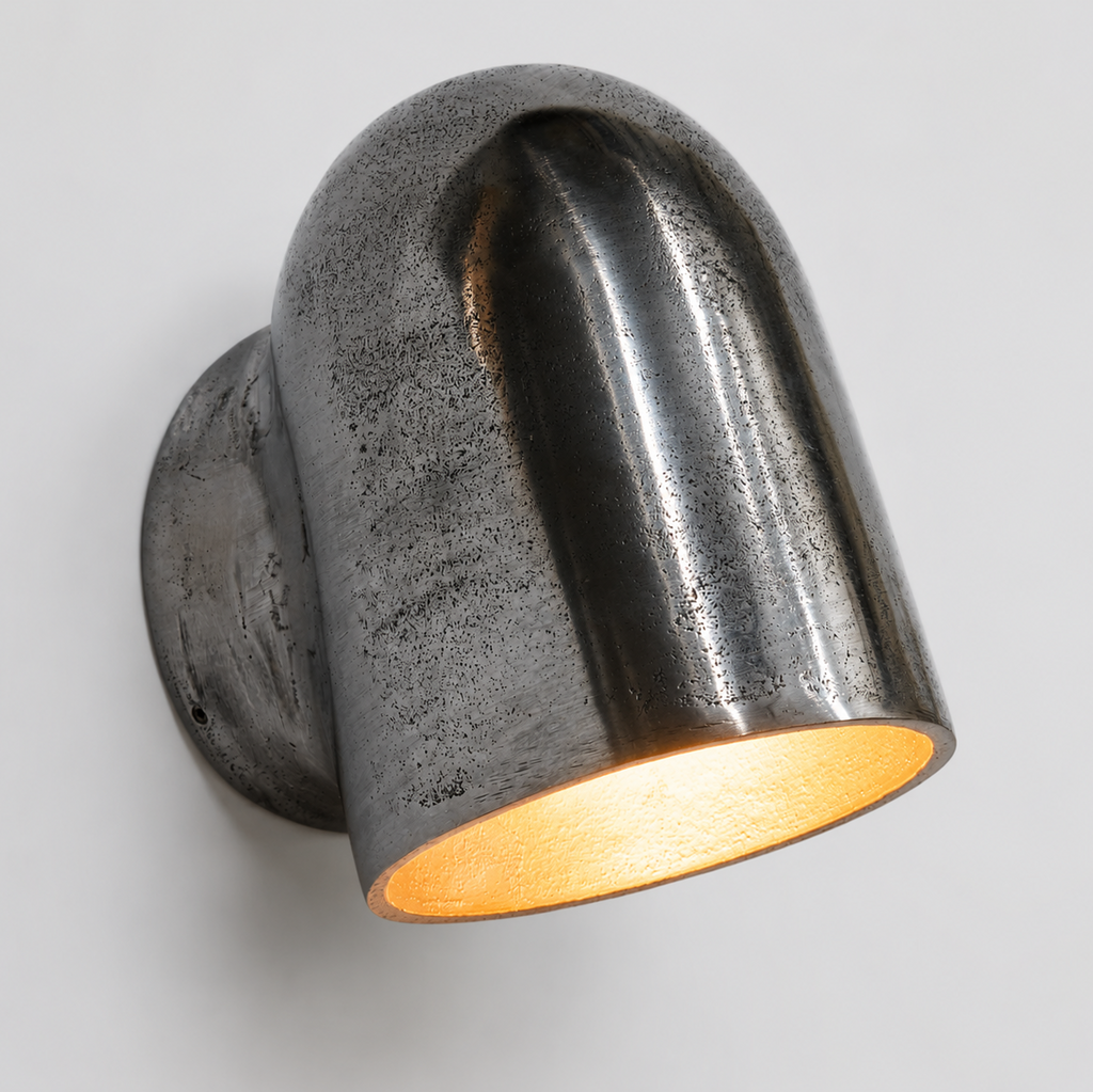 Metal wall light fixture on a gray background