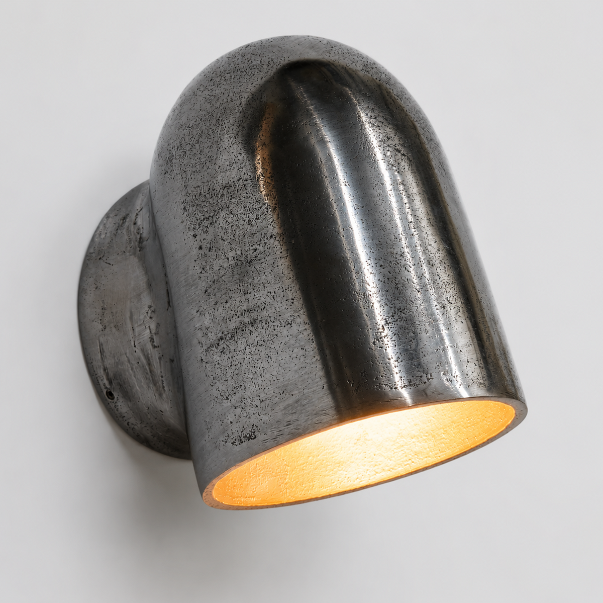Metal wall light fixture on a gray background