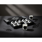 Set of candles with decorative packaging on a dark surface