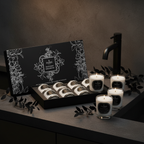 Set of candles with a decorative box on a dark surface
