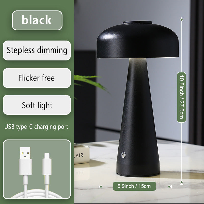 Black table lamp with USB charging cable on a neutral background