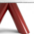 Close-up of a table base with glossy red V-shaped legs and a white marble tabletop edge on a white background.