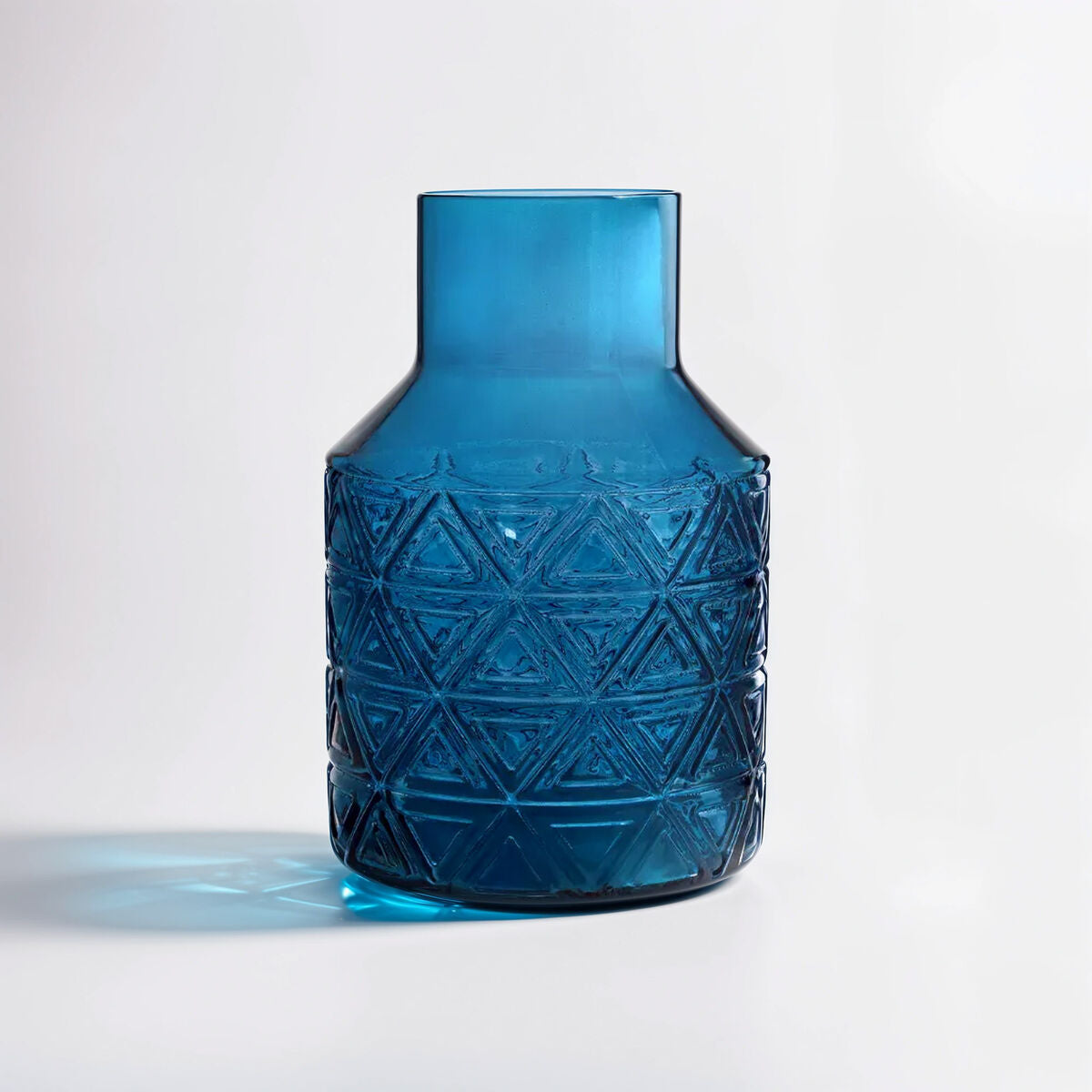 Blue textured vase on a light gray background