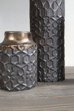 Two decorative vases with intricate patterns on a wooden surface.