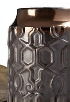 Decorative vase with metallic finish and geometric pattern on a white background