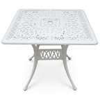 White metal outdoor table with intricate design on a white background