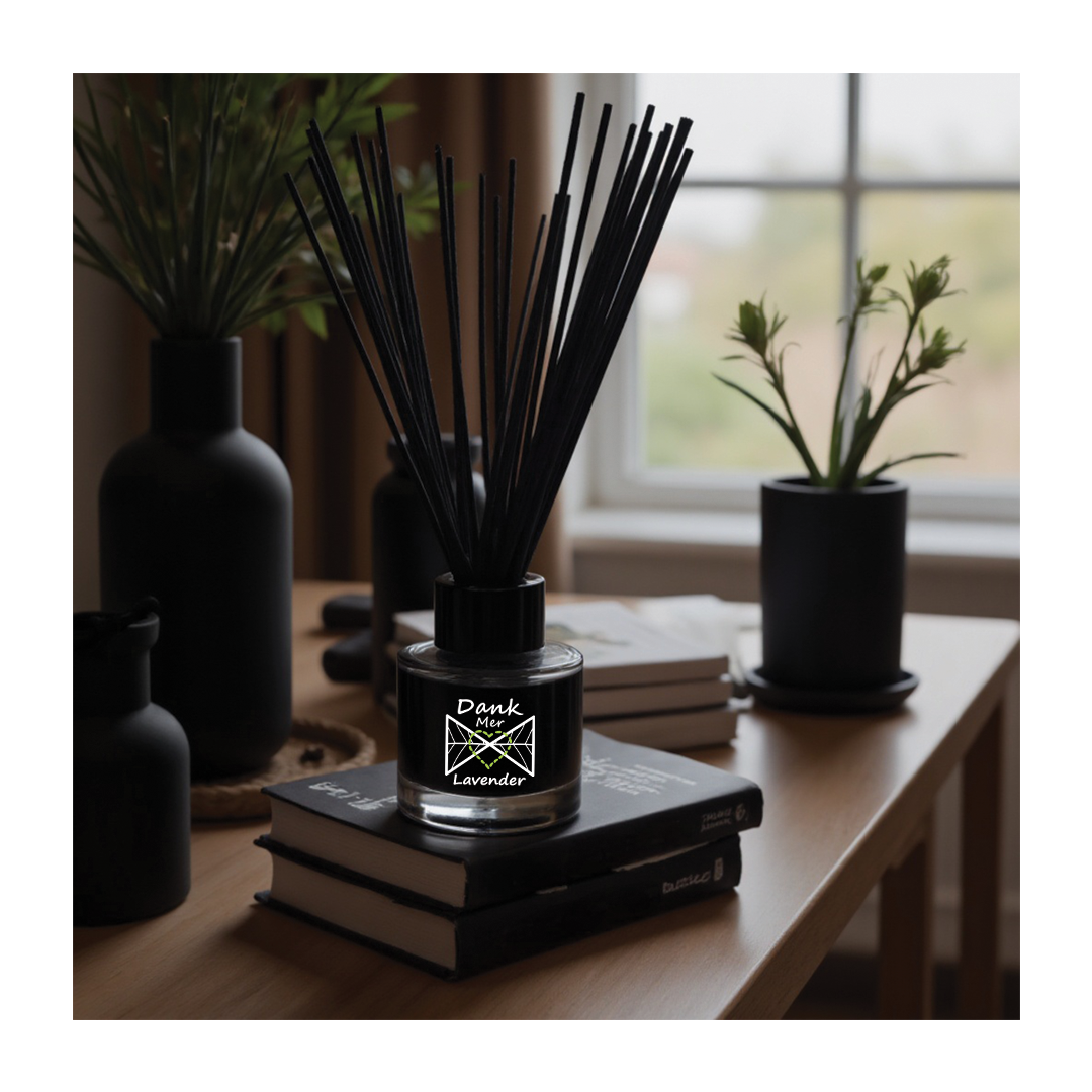 Black diffuser bottle labeled 'Dank Lavender' on books with plants in the background