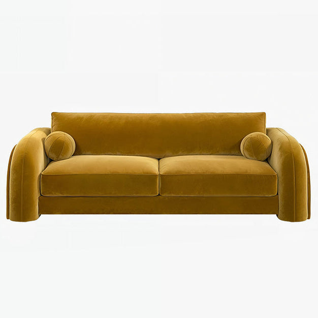 Mustard yellow sofa with curved armrests on a white background