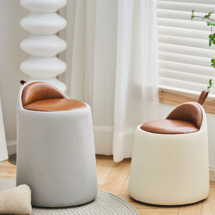 Two small stools with brown seats and white bodies in a room with light-colored curtains and wooden flooring.