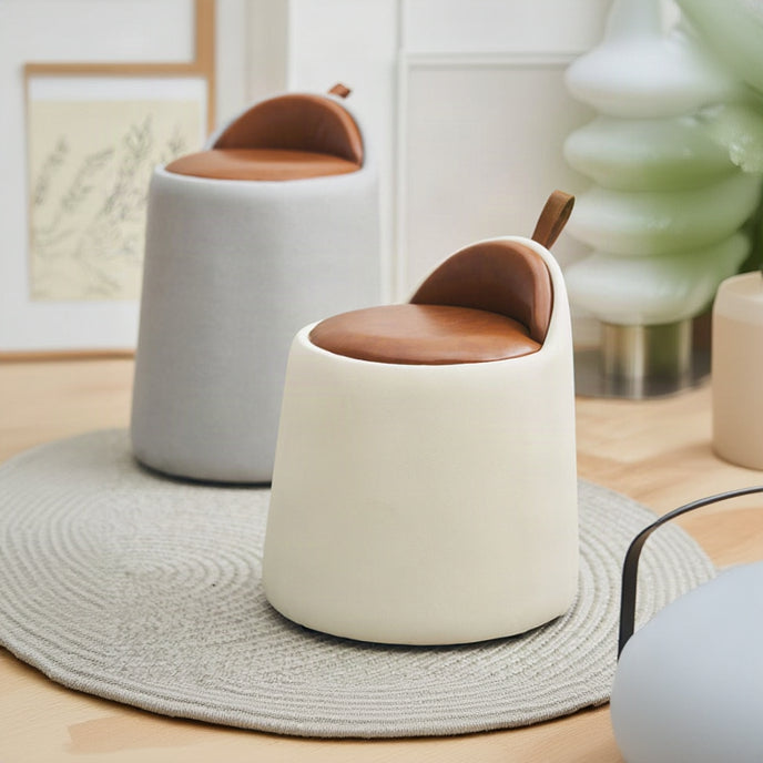 Two modern stools with brown seats and white bases in a room setting.