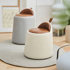 Two modern stools with brown seats and white bases in a room setting.