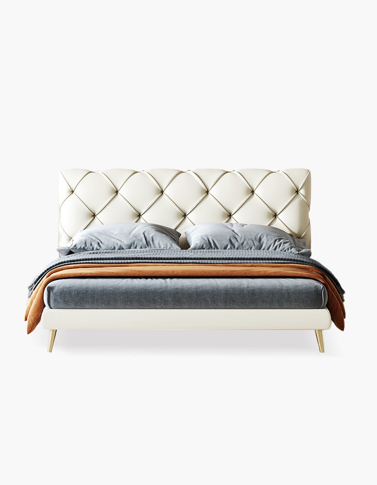 Modern bed with tufted headboard and gray bedding on a white background