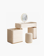 Beige vanity table with round mirror and stool on a white background