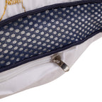 Close-up of a cushion with a textured surface and zipper detail on a white background