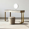 Dressing table with a round mirror and stool in a minimalistic setting