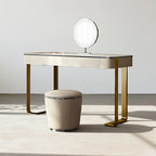 Dressing table with a round mirror and stool in a minimalistic setting