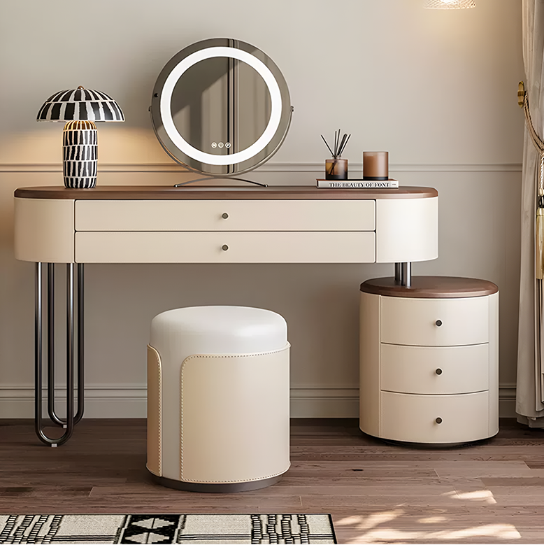 Dressing table with mirror, stool, and small cabinet in a room setting.