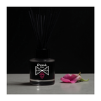 Black diffuser bottle with 'Dank Mix' label and a pink flower on a dark background