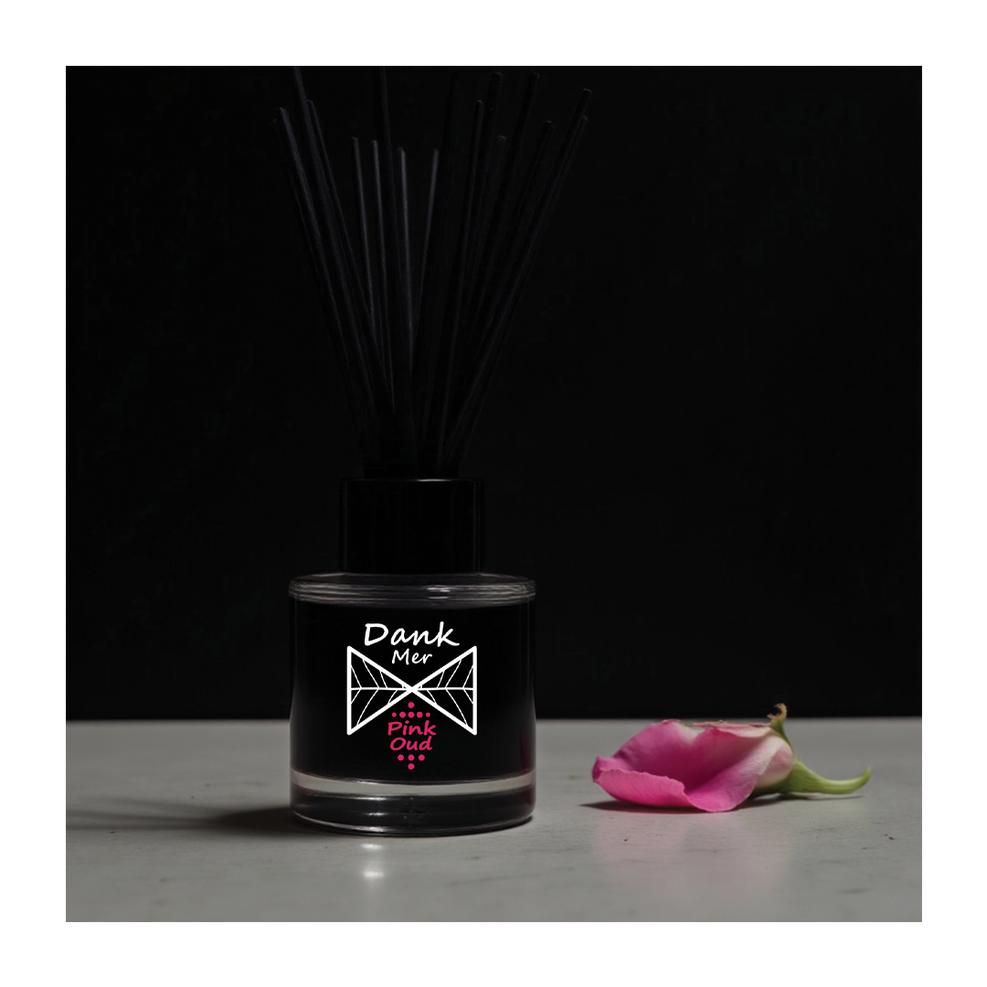 Black diffuser bottle with 'Dank Mix' label and a pink flower on a dark background