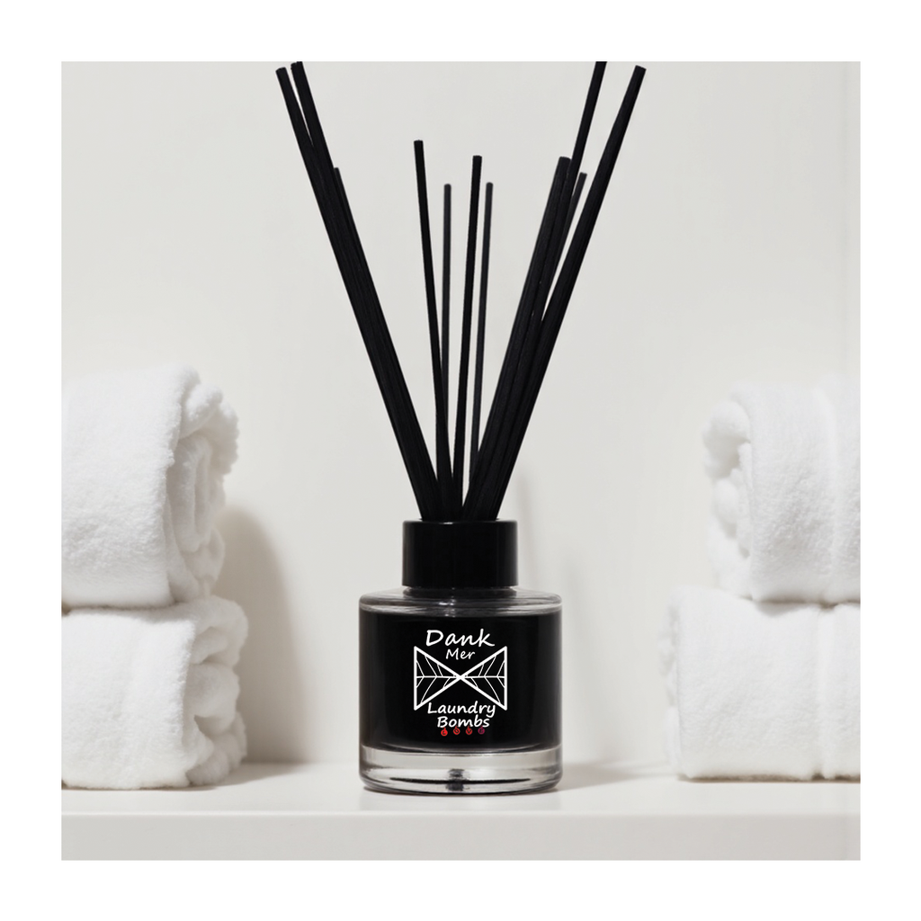 Black diffuser bottle with reeds on a white background