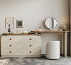 Dressing table with mirror, stool, and decorative items in a room setting.