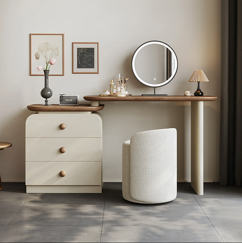 Dressing table with mirror, stool, and decorative items in a room setting.