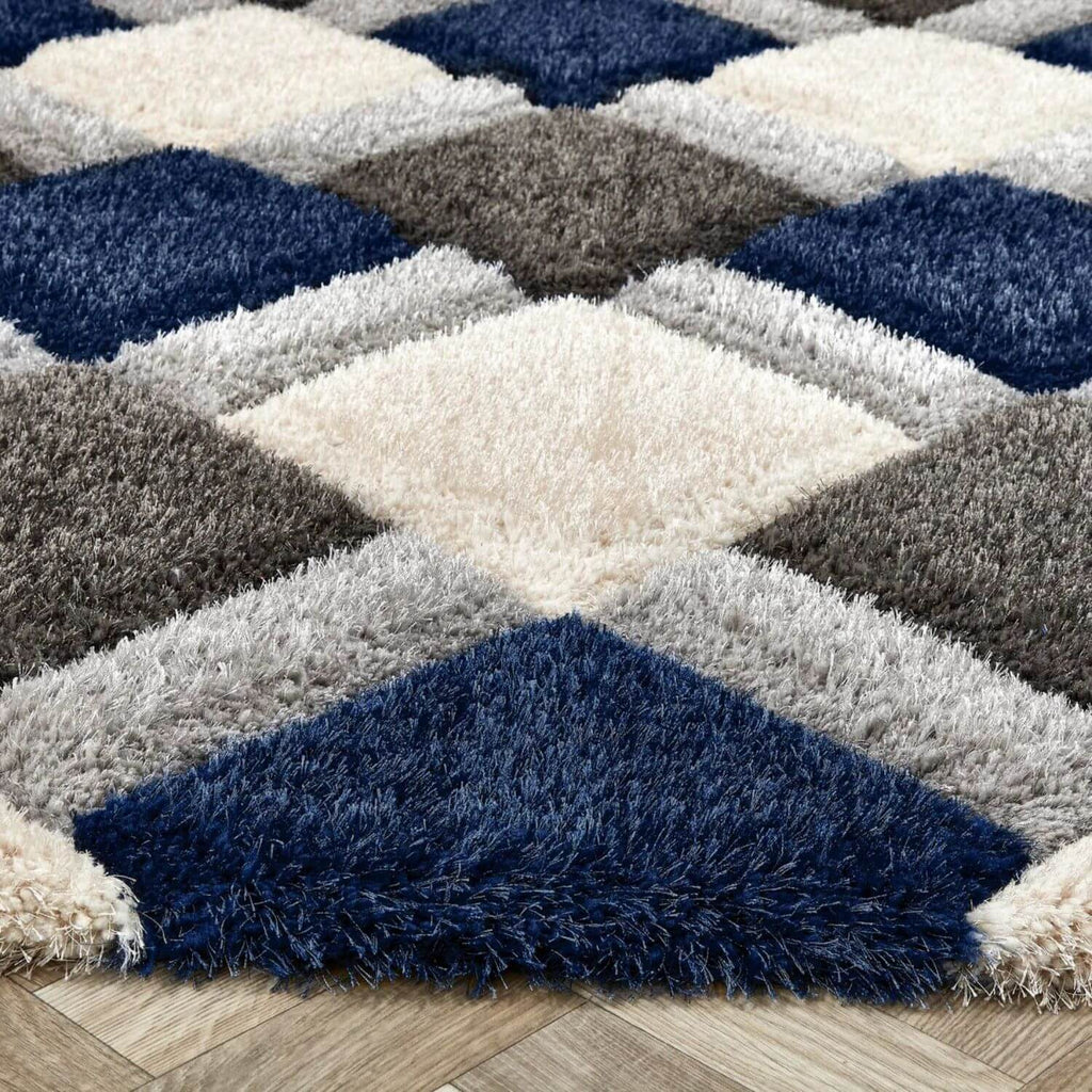 Geometric patterned rug with blue, gray, and beige colors on a wooden floor.