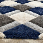 Geometric patterned rug with blue, gray, and beige colors on a wooden floor.