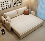 Beige sectional sofa with decorative pillows in a living room setting.