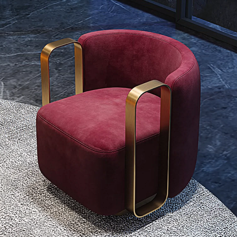 Red velvet chair with gold armrests on a textured floor with a dark outdoor background