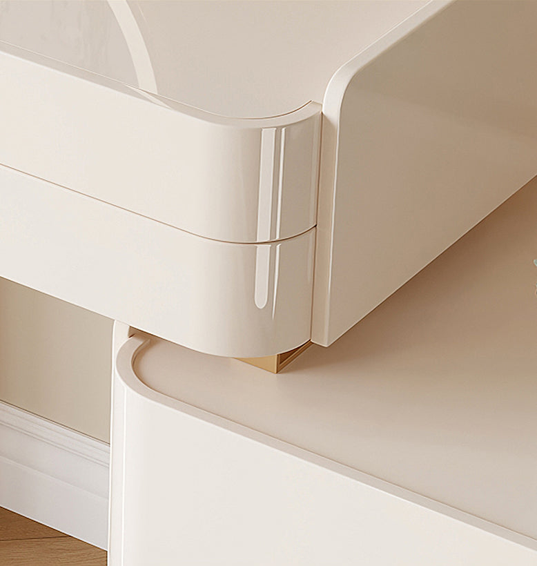 Close-up of a white curved desk with a gold accent