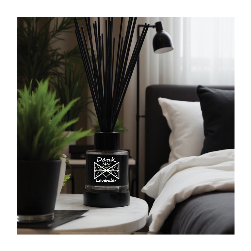 Black diffuser on a table with a plant and lamp in a room setting