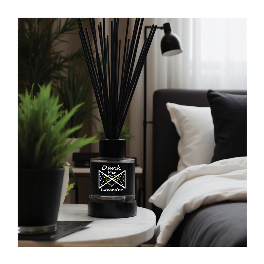 Black diffuser on a table with a plant and lamp in a room setting