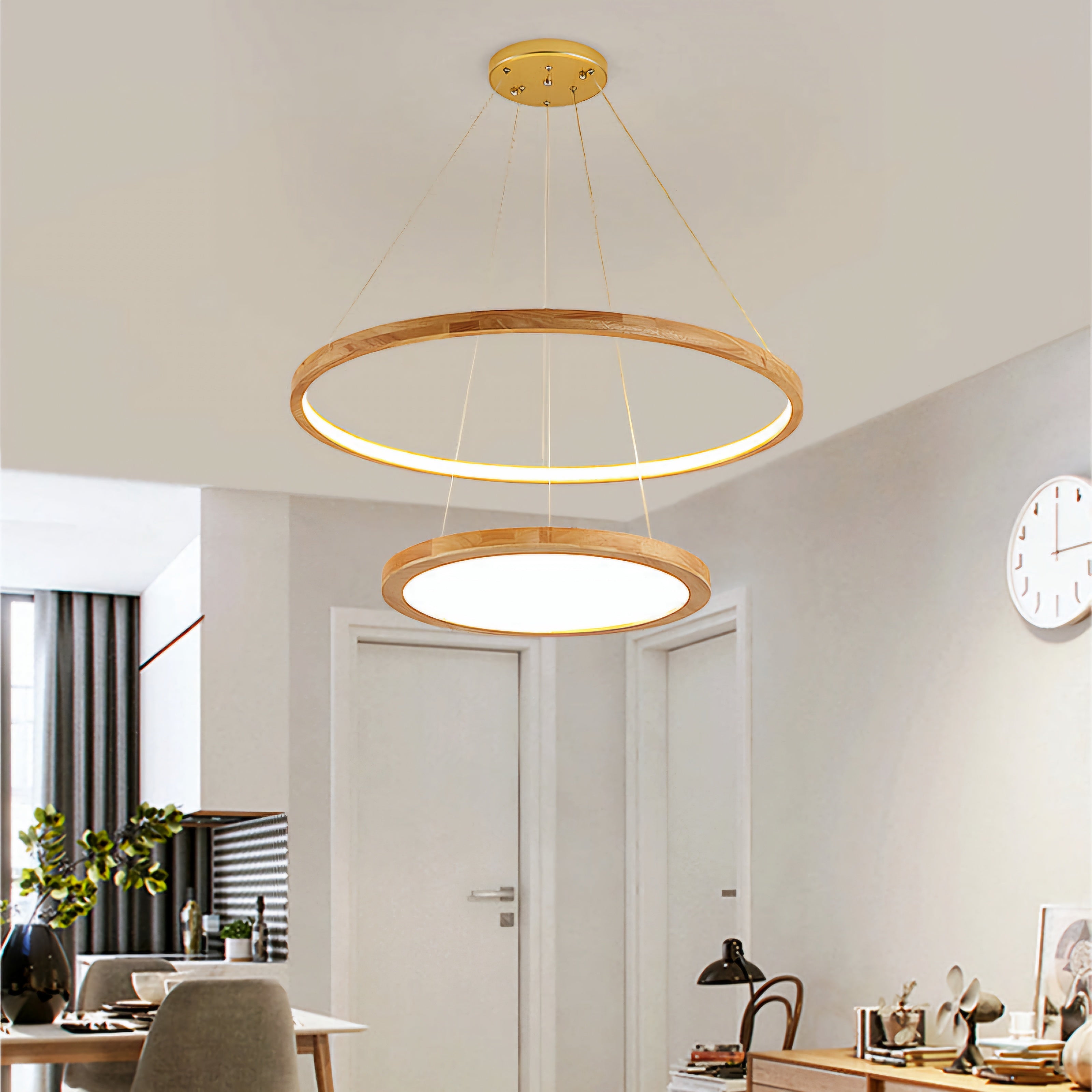 A modern two-ring linear LED pendant light with natural wood frames hanging in a bright, contemporary home office or dining space.