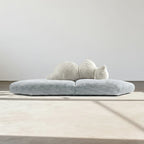 Modern gray sofa with a white cushion on a neutral background