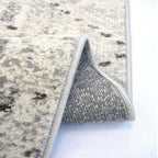 Close-up of a textured rug with a metallic border on a white background