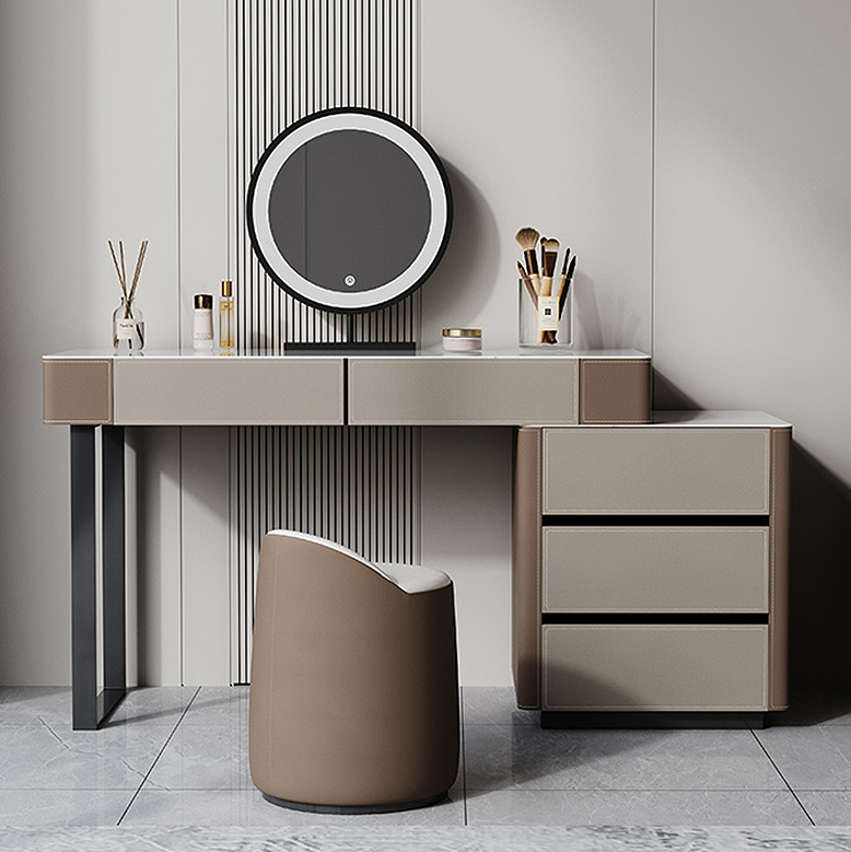 Modern vanity desk with round mirror and decorative items in a minimalistic room.