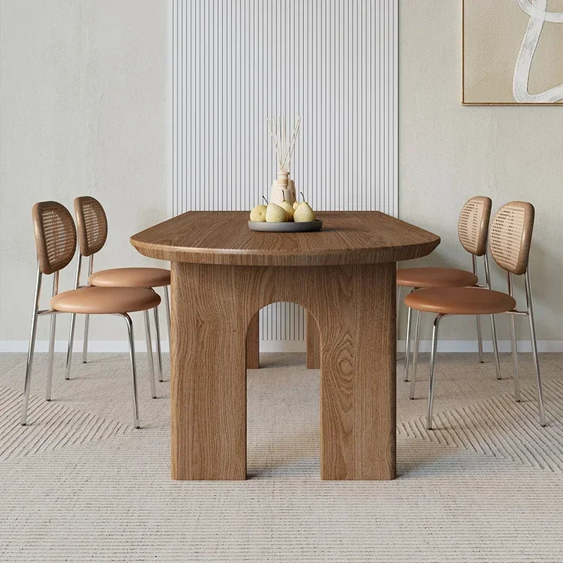 Wooden dining table with four chairs in a modern room setting.