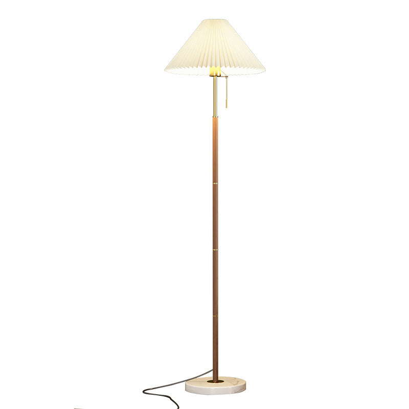 Floor lamp with pleated shade on a white background