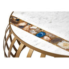 Decorative round table with a marble-like surface and gold metal base on a white background