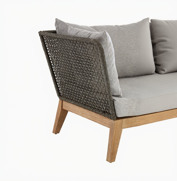 Chair with woven backrest and gray cushions on a white background