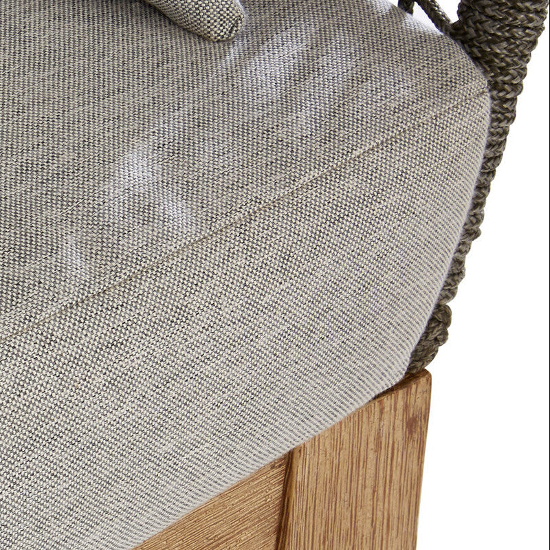 Close-up of a textured gray cushion on a wooden chair