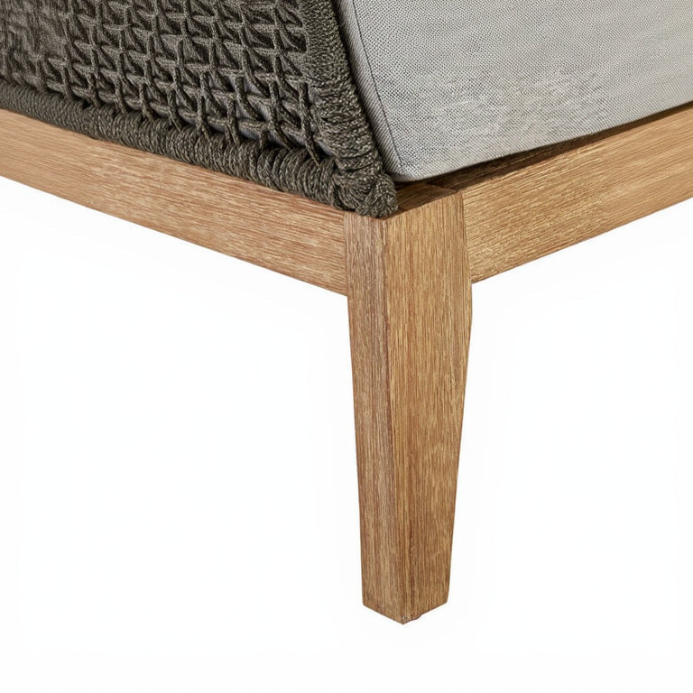 Close-up of a wooden chair with woven backrest and gray cushion on a white background