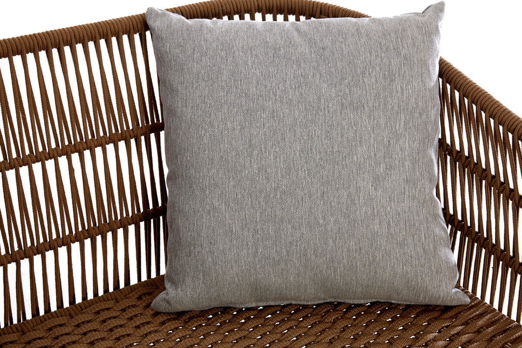 Gray pillow on a wicker chair