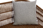 Gray pillow on a wicker chair